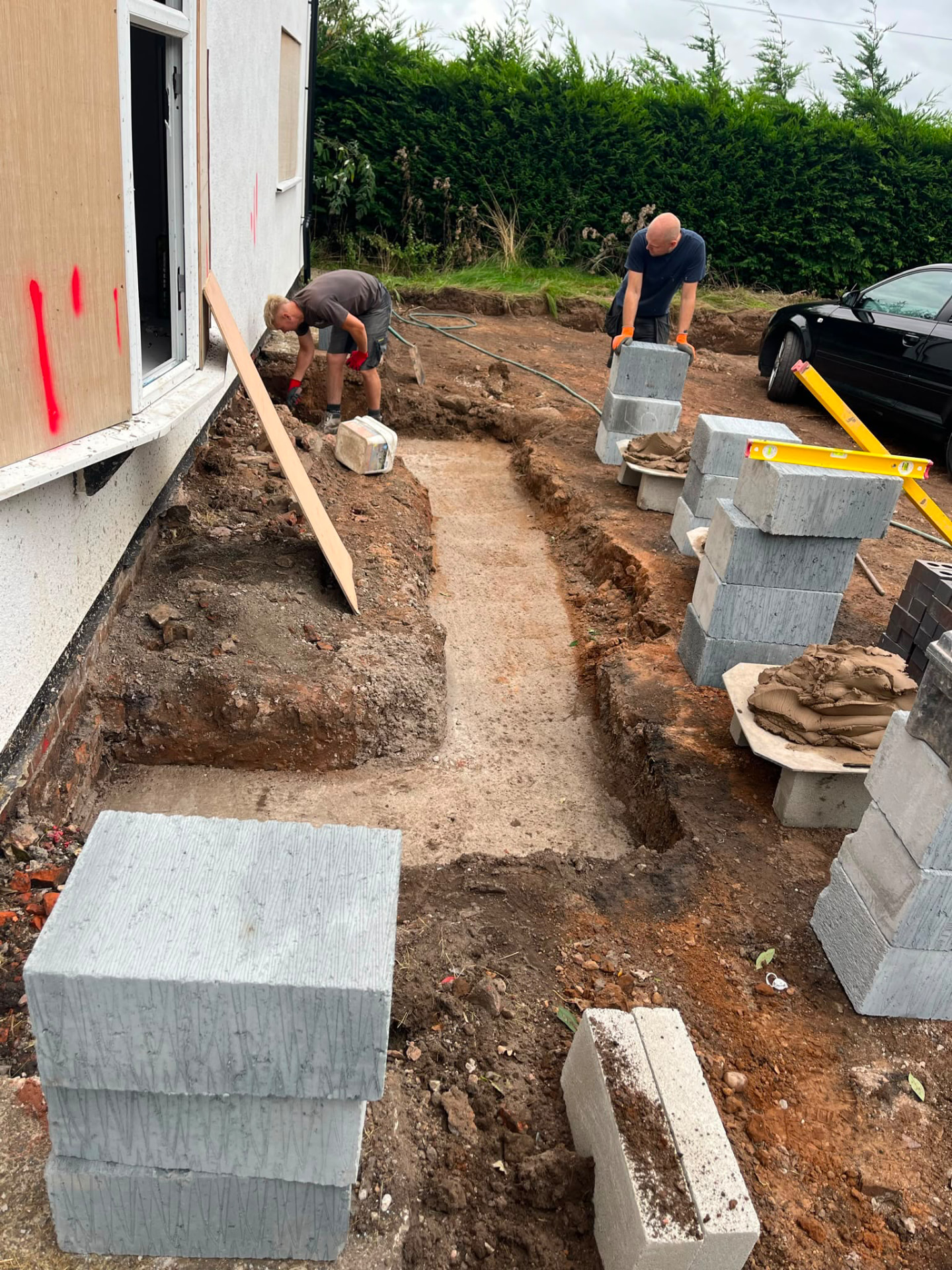 Foundation trenches dug alongside the cottage ready for the new extension
