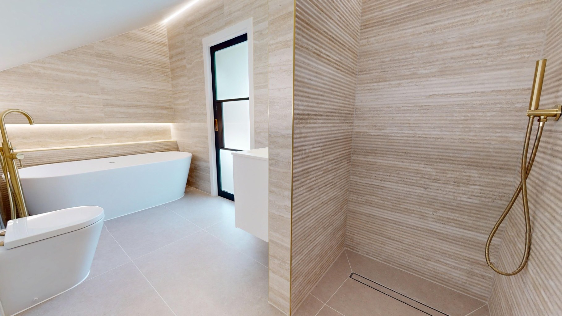 Top floor bathroom with freestanding bath, walk-in shower and brass fittings