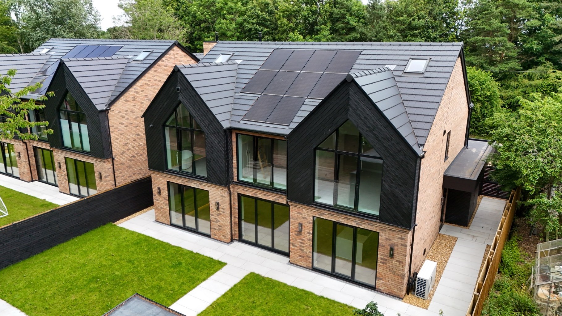 Aerial view of a completed bespoke home with landscaped garden