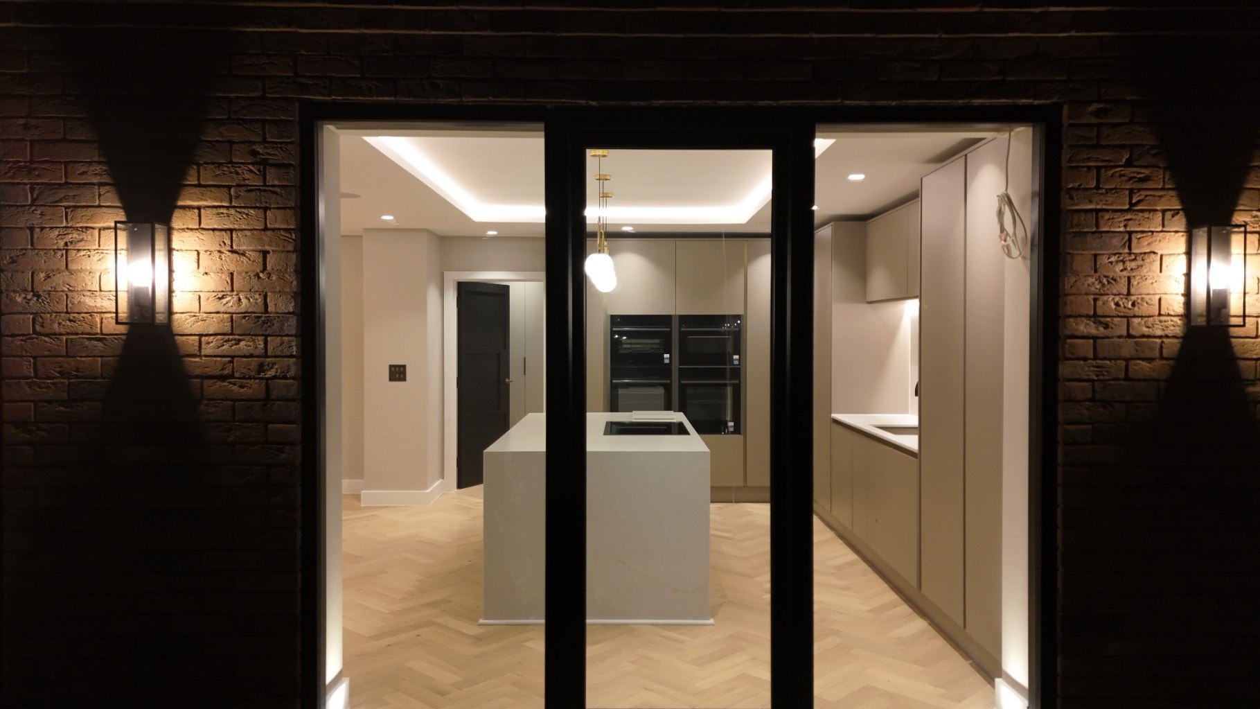 Grand reception hallway with brick detailing and wall lighting