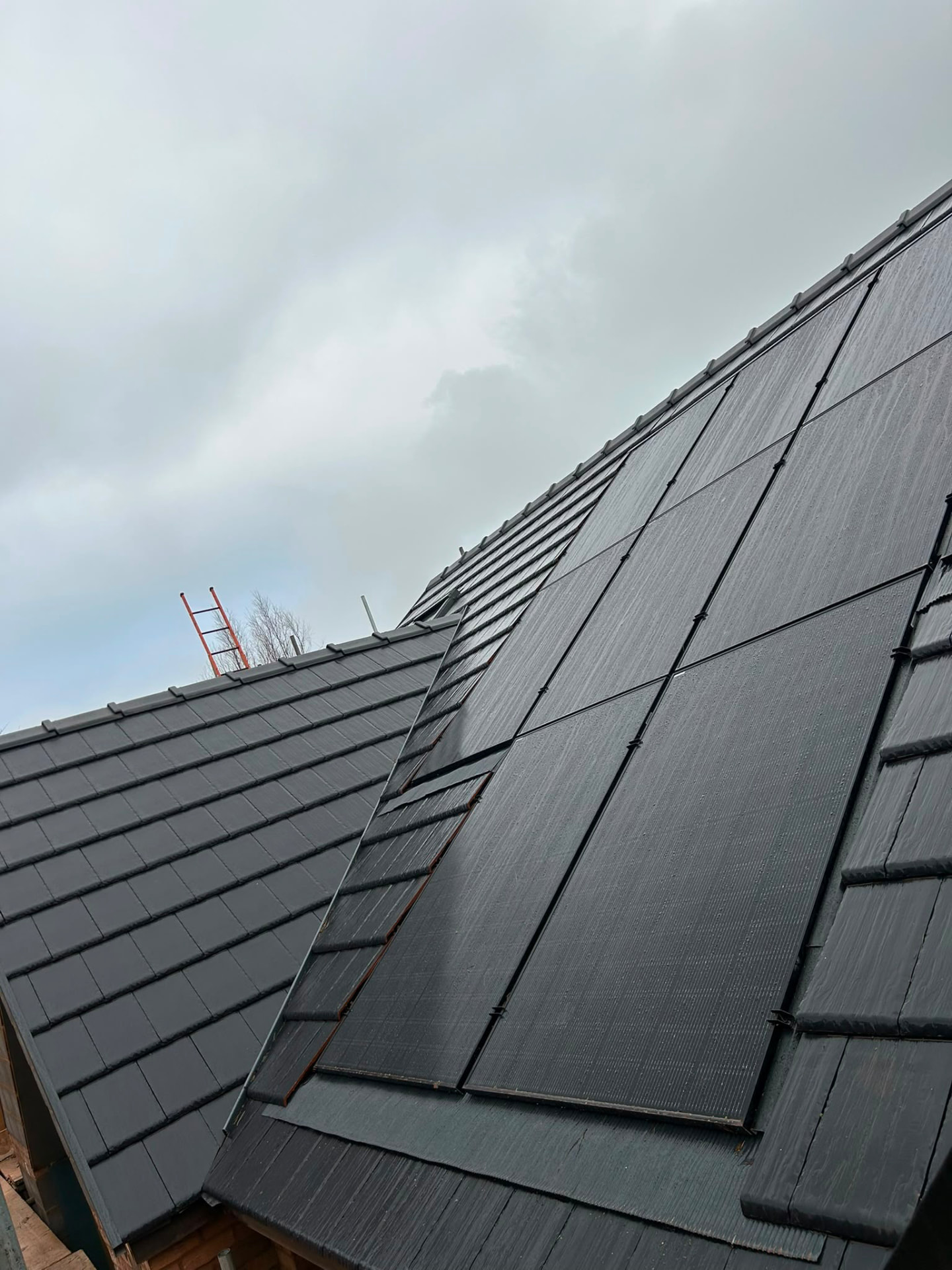 In-roof solar panels set within a black tiled roof